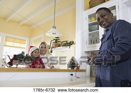 Low angle view of an inter-racial family in the kitchen View Large Photo Image Stock Image - Low angle view of an inter-racial family in the kitchen. Fotosearch