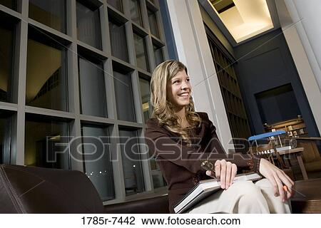 Low angle view of student sitting in the library View Large Photo Image Stock Image - Low angle view of student sitting in the library. Fotosearch