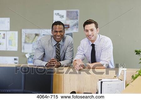 Male co-workers hanging out at office View Large Photo Image Stock Photography - Male co-workers hanging out at office. Fotosearch