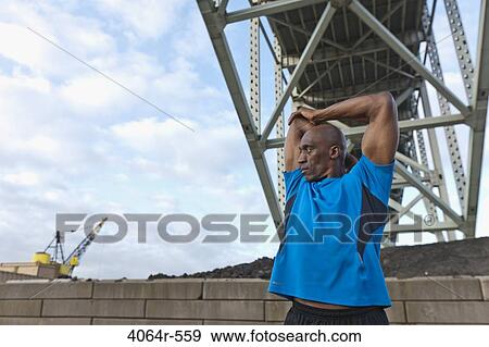 Male urban athlete stretching View Large Photo Image Stock Photo - Male urban athlete stretching. Fotosearch