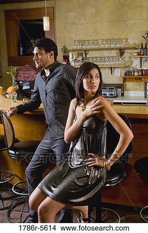 Man and woman in restaurant looking in opposite directions View Large Photo Image Picture - Man and woman in restaurant looking in opposite directions. Fotosearch