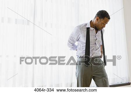 Man getting dressed View Large Photo Image Picture - Man getting dressed. Fotosearch