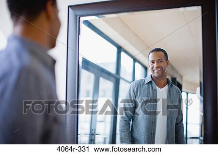 Stock Image - Man getting dressed. Fotosearch
