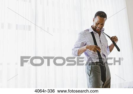 Man getting dressed View Large Photo Image Stock Photograph - Man getting dressed. Fotosearch