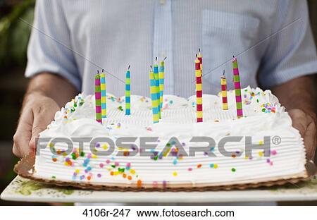 Man holding birthday cake, mid section View Large Photo Image Stock Photo - Man holding birthday cake, mid section. Fotosearch