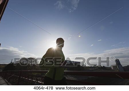 Man jogging, backlit by sun View Large Photo Image Stock Photo - Man jogging, backlit by sun. Fotosearch