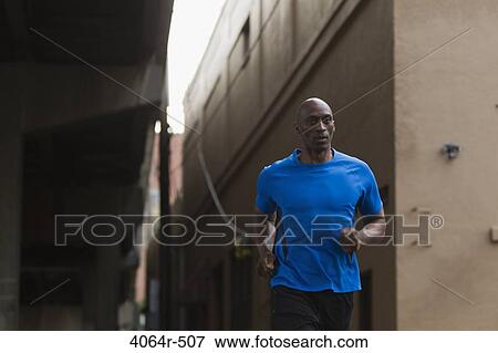 Man jogging in street View Large Photo Image Stock Photo - Man jogging in street. Fotosearch