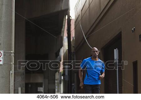 Man jogging in street View Large Photo Image Stock Photograph - Man jogging in street. Fotosearch