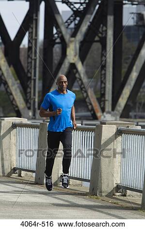 Man jogging in street View Large Photo Image Stock Photograph - Man jogging in street. Fotosearch