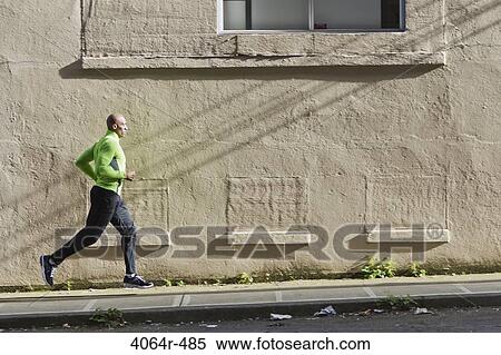 Man jogging up street View Large Photo Image Stock Photography - Man jogging up street. Fotosearch