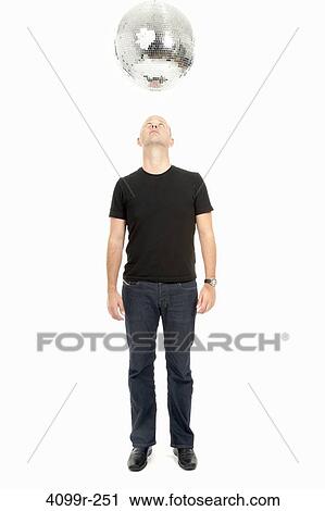 Man looking up at disco mirror ball View Large Photo Image Stock Image - Man looking up at disco mirror ball. Fotosearch