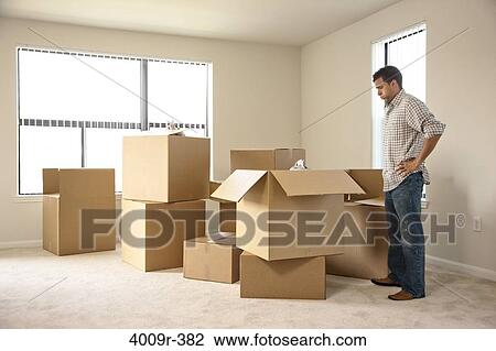 Man moving into new house View Large Photo Image Stock Image - Man moving into new house. Fotosearch