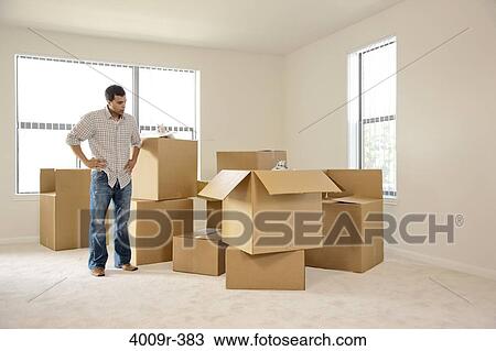 Man moving into new house View Large Photo Image Stock Image - Man moving into new house. Fotosearch