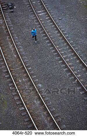 Man running across railroad tracks View Large Photo Image Stock Image - Man running across railroad tracks. Fotosearch