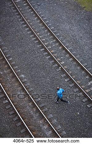 Man running across railroad tracks View Large Photo Image Stock Photography - Man running across railroad tracks. Fotosearch