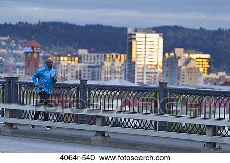 Man running along bridge View Large Photo Image Stock Image - Man running along bridge. Fotosearch