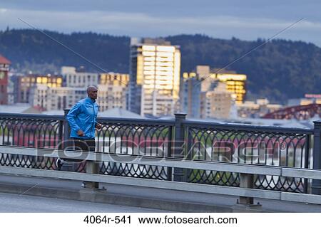 Man running along bridge View Large Photo Image Stock Image - Man running along bridge. Fotosearch
