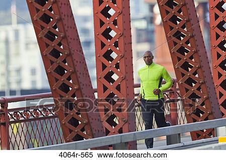 Man running along bridge View Large Photo Image Stock Photography - Man running along bridge. Fotosearch