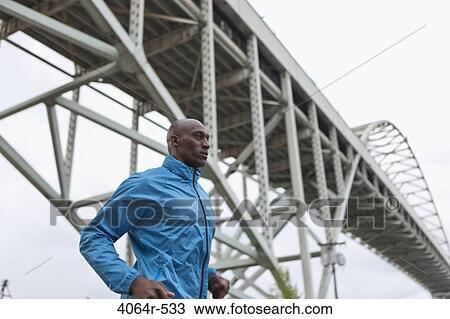 Man running underneath bridge View Large Photo Image Stock Image - Man running underneath bridge. Fotosearch