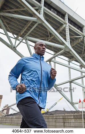 Man running underneath bridge View Large Photo Image Stock Photo - Man running underneath bridge. Fotosearch