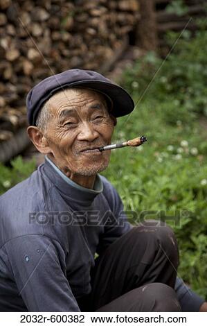 Man smoking a cigar, Kunming, Yunnan Province, China View Large Photo Image Stock Image - Man smoking a cigar, Kunming, Yunnan Province, China. Fotosearch