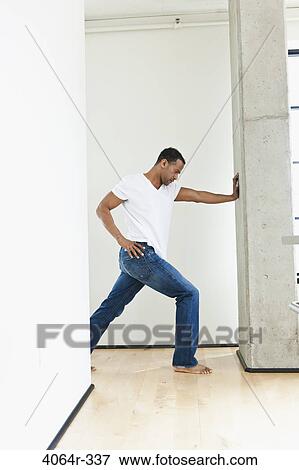 Man stretching in loft apartment View Large Photo Image Stock Photo - Man stretching in loft apartment. Fotosearch