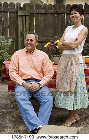 Mature couple next to a picnic table in backyard View Large Photo Image Stock Image - Mature couple next to a picnic table in backyard. Fotosearch