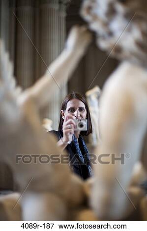 Mature woman taking a picture of statues in a museum, Paris, France View Large Photo Image Stock Photo - Mature woman taking a picture of statues in a museum, Paris, France. Fotosearch