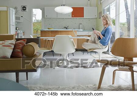 Mature woman text messaging at home View Large Photo Image Stock Image - Mature woman text messaging at home. Fotosearch