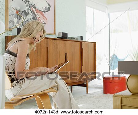 Mature woman using a digital tablet View Large Photo Image Stock Image - Mature woman using a digital tablet. Fotosearch