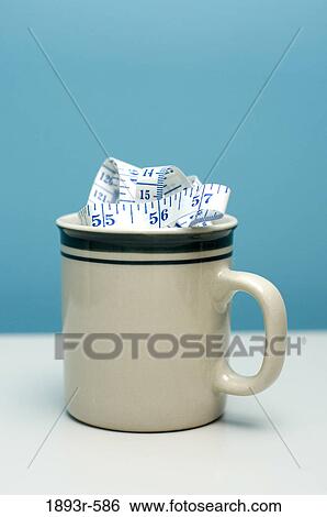measuring tape resembling cappucino froth in a cup representing high-calory coffee drinks View Large Photo Image Stock Photograph - measuring tape resembling cappucino froth in a cup representing high-calory coffee drinks. Fotosearch
