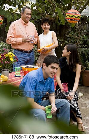 Mexican-American family at a picnic table the backyard View Large Photo Image Stock Photo - Mexican-American family at a picnic table the backyard. Fotosearch