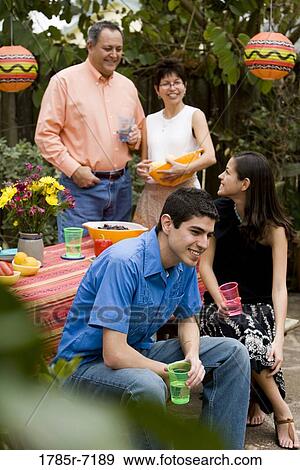 Mexican-American family at a picnic table the backyard View Large Photo Image Stock Photo - Mexican-American family at a picnic table the backyard. Fotosearch