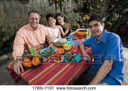 Mexican-American family enjoying a picnic in the backyard View Large Photo Image Stock Image - Mexican-American family enjoying a picnic in the backyard. Fotosearch