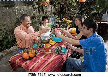 Stock Photo - Mexican-American family enjoying a picnic in the backyard. Fotosearch
