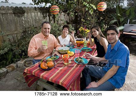 Mexican-American family enjoying a picnic in the backyard View Large Photo Image Stock Photo - Mexican-American family enjoying a picnic in the backyard. Fotosearch