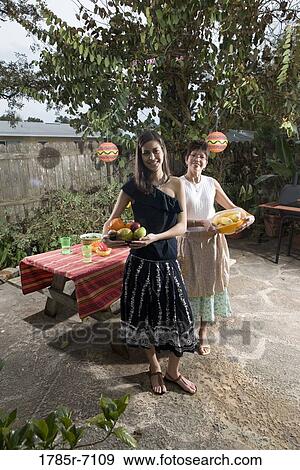 Mexican-American mother and daughter setting a picnic table View Large Photo Image Stock Photo - Mexican-American mother and daughter setting a picnic table. Fotosearch