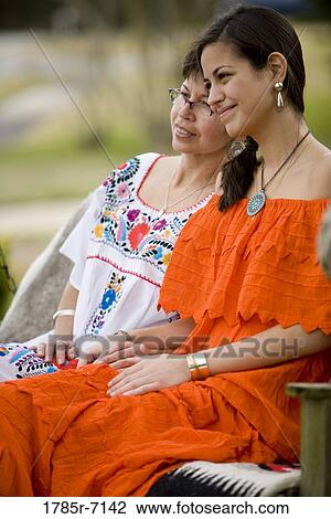 Mexican mother and daughter sitting together View Large Photo Image Stock Image - Mexican mother and daughter sitting together. Fotosearch