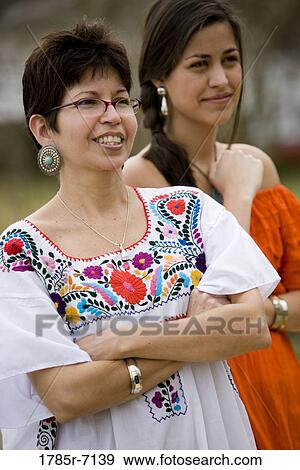 Mexican mother and daughter standing together View Large Photo Image Stock Photo - Mexican mother and daughter standing together. Fotosearch
