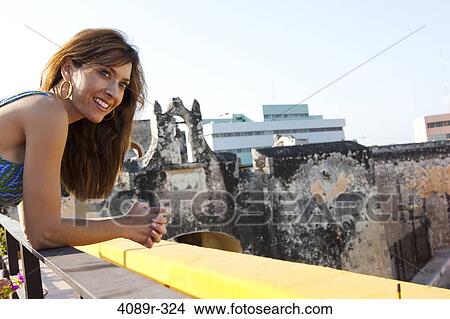 Picture - Mexico, Campeche, Fort Of San Miguel, Mid adult woman smiling with fort in background. Fotosearch
