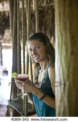 Mexico, Portrait of woman holding margarita and smiling View Large Photo Image Stock Image - Mexico, Portrait of woman holding margarita and smiling. Fotosearch
