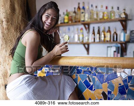 Mexico, Yucatan Peninsula, Quintana Roo, Tulum, Young woman drinking glass of margarita in bar View Large Photo Image Stock Photograph - Mexico, Yucatan Peninsula, Quintana Roo, Tulum, Young woman drinking glass of margarita in bar. Fotosearch
