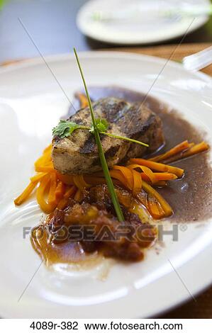 Stock Image - Mexico, Yucatecan, close up of Mayan tuna steak with carrots. Fotosearch