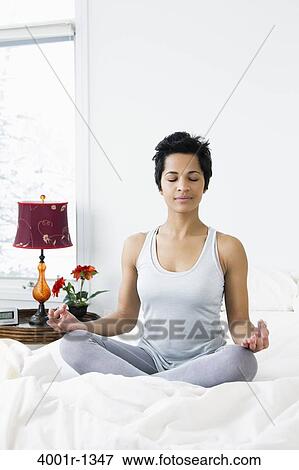Mid adult woman doing siddhasana on the bed View Large Photo Image Stock Photo - Mid adult woman doing siddhasana on the bed. Fotosearch