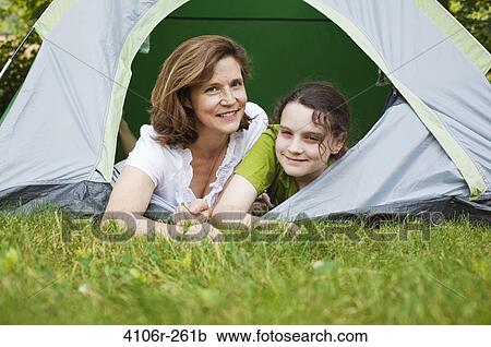 Mother and daughter lying in tent View Large Photo Image Stock Image - Mother and daughter lying in tent. Fotosearch