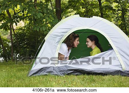 Mother and daughter sitting face to face in tent View Large Photo Image Stock Image - Mother and daughter sitting face to face in tent. Fotosearch
