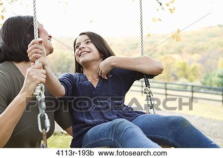 Mother with daughter on swing View Large Photo Image Stock Image - Mother with daughter on swing. Fotosearch