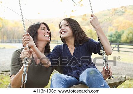Mother with daughter on swing View Large Photo Image Stock Image - Mother with daughter on swing. Fotosearch