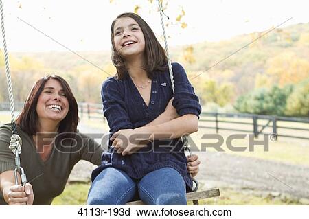 Mother with daughter on swing View Large Photo Image Stock Image - Mother with daughter on swing. Fotosearch