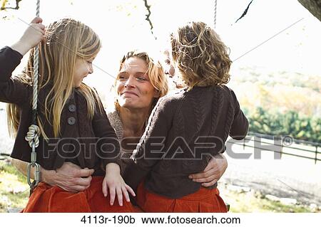 Mother with two daughters on swing View Large Photo Image Stock Image - Mother with two daughters on swing. Fotosearch